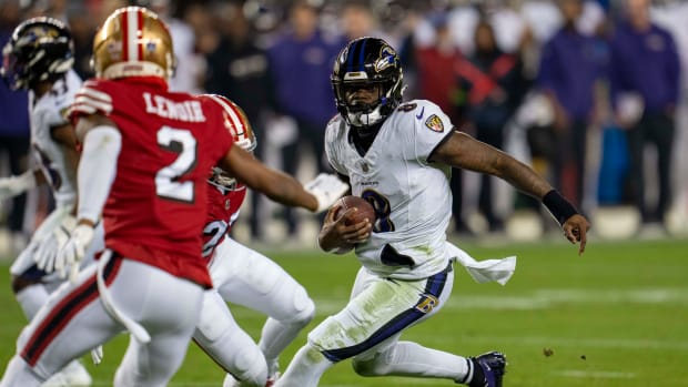 Dec 25, 2023; Santa Clara, California, USA; Baltimore Ravens quarterback Lamar Jackson (8) scrambles with the football against San Francisco 49ers safety Ji'Ayir Brown (27) during the second quarter at Levi's Stadium. Mandatory Credit: Neville E. Guard-USA TODAY Sports  